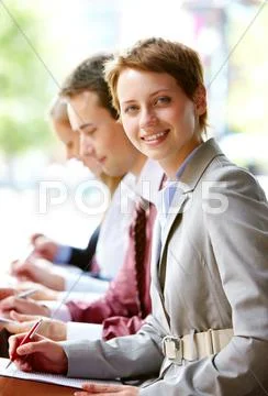 Group of happy successful people in line with focus on woman Stock Photos