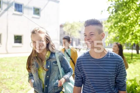Group of happy teenage students walking outdoors Stock Photos