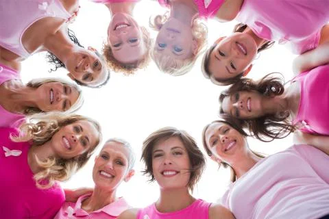 Group of happy women in circle wearing pink for breast cancer Stock Photos