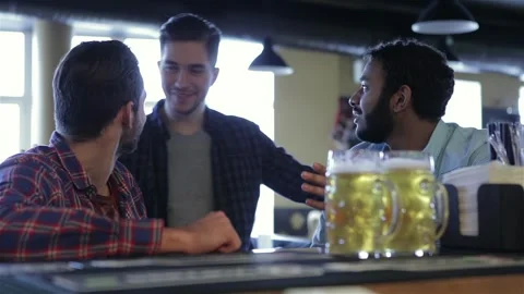 Group of happy young friends drinking beer Stock Footage 252084733