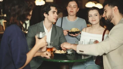 Group of happy young friends having fun together in beer pub Stock Footage 343283508