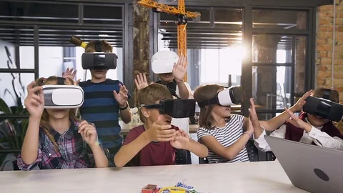 Group of happy young pupils of elementary school using virtual reality headsets Stock Footage 115102132