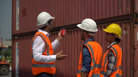 Group of harbor worker with foreman talking on the walkie-talkie control load Stock Footage 159394370