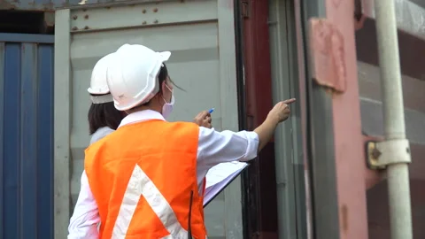 Group of harbor worker wearing face mask discussion and using clipboard check Stock Footage 157716285