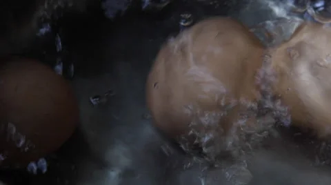 A group of hard boiled eggs in boiling water Stock Footage 68540813