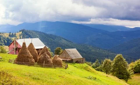 Group of haystack against hills in Carpathian mountains. Foto stock