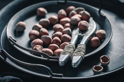 Group of hazelnuts with a old metal nutcracker Stock Photos