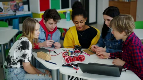 Group of high school students building and programming electric toys and robots Stock Footage 200779097