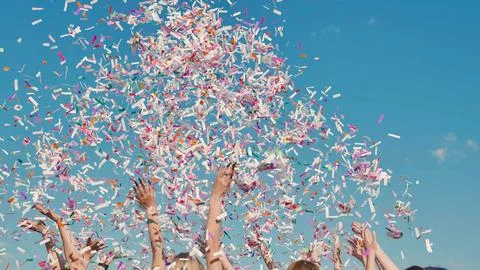 Group of high school students throwing colorful confetti in the air celebrating Stock Photos