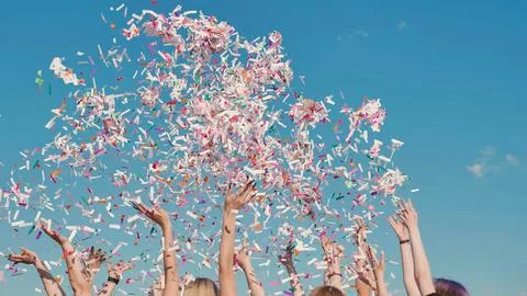 Group of high school students throwing colorful confetti in the air celebrating Stock Photos