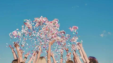 Group of high school students throwing colorful confetti in the air celebrating Stock Photos