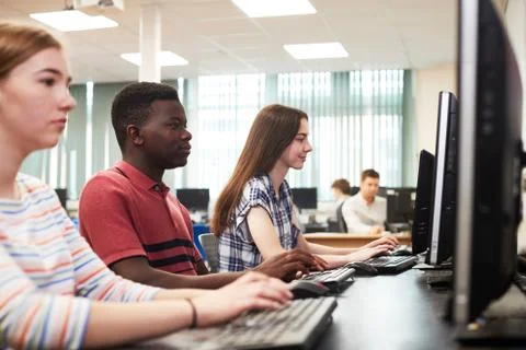 Group Of High School Students Working Together In Computer Class 库存照片