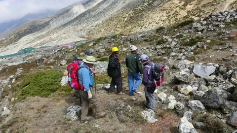 Group of hikers climbing the hill Stock Footage 77450258