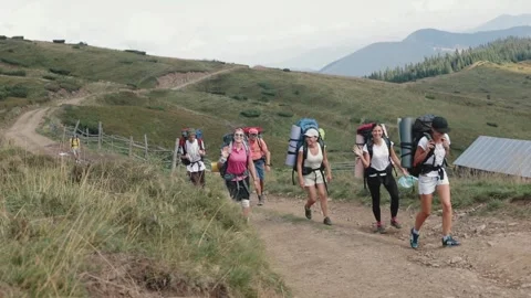 Group of hikers exploring mountains under blue sky Stock Footage 307423829