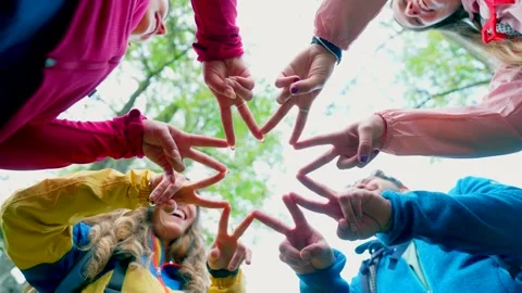 Group of hikers forming a star shape with hands Stock Footage 333387566