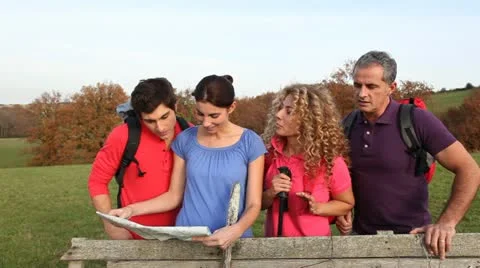 Group of hikers looking at map Stock Footage 14832497