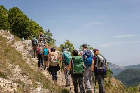 Group of hikers on the mountain path. Stock Photos