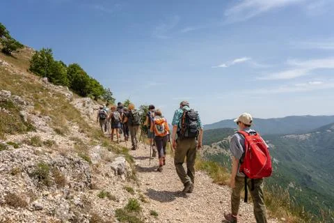 Group of hikers on the mountain path. Stock Photos