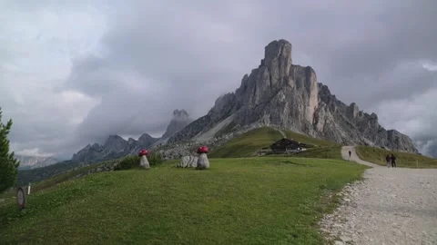 Group of hikers observing towering cliffs of Cinque Torri in the Dolomitines Stock Footage 318384928
