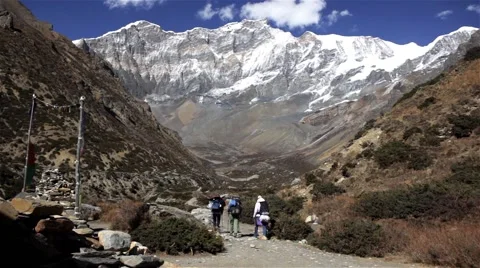 Group of hikers walk between wild mountains Stock Footage 67647132