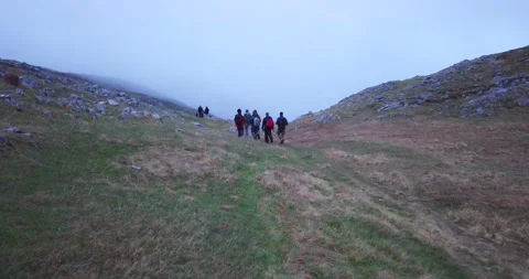 Group of hikers walking on a mountain Stock Footage 132303789