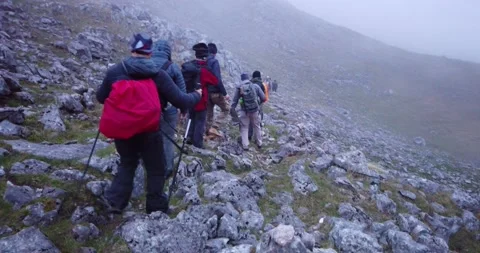 Group of hikers walking on a mountain Video stock 132303936
