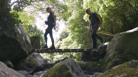 Group of hikers walking over a bridge on São Jorge island, Azores Stock Footage 230287432