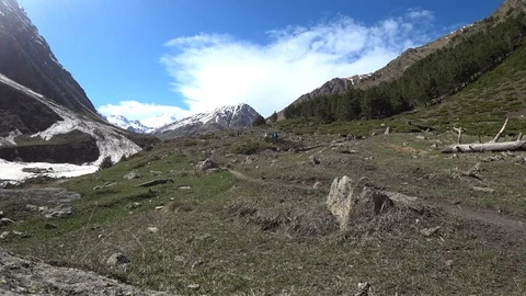 A group of hikers is walking on the pathway with mountains background Video stock 90492027