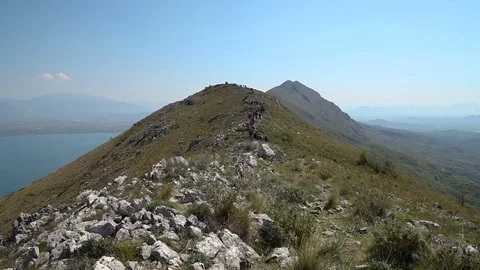 Group of hikers walking towards the mountain peak Stock Footage 79797404