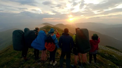 A group of hikers watching the sunset Stock Footage 99008486