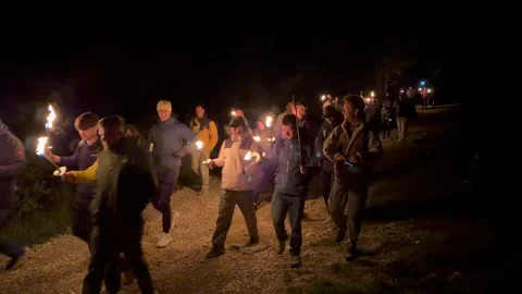 Group Hiking At Night With Torchlight, On Dark Trail Stock Footage 323683122