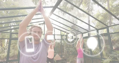 Group holding yoga Tree Pose as 3s mark causing computer monitor and five icons Stock-Footage 317405580