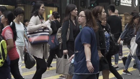 Group of Hong Kong Chinese People Walking in Crosswalk Slow Motion Stock Footage