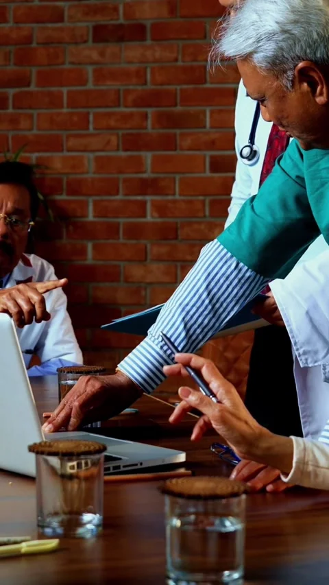 Group of indian doctors and surgeons discussing case in hispital while standing Stock Footage 342803842
