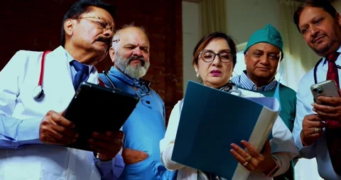 Group of indian doctors and surgeons discussing case in hispital while standing Stock Footage 342806504