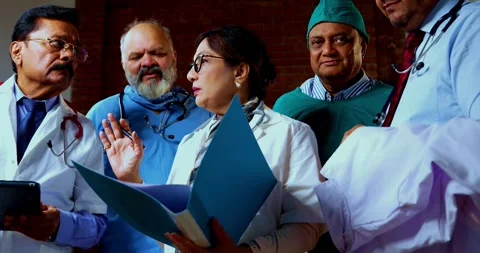Group of indian doctors and surgeons discussing case in hispital while standing Stock Footage 342806507