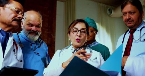 Group of indian doctors and surgeons discussing case in hispital while standing Stock Footage 342806516