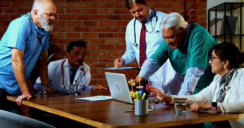 Group of indian doctors and surgeons discussing case in hispital while standing Video stock 342806543