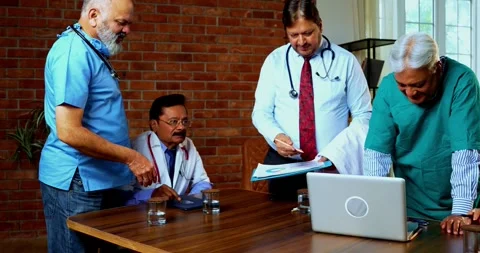 Group of indian doctors and surgeons discussing case in hispital while standing Stock Footage 342806553