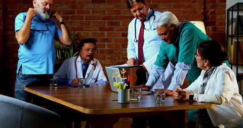Group of indian doctors and surgeons discussing case in hispital while standing Stock Footage 342806911