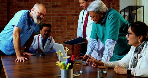 Group of indian doctors and surgeons discussing case in hispital while standing Stock Footage 342806926