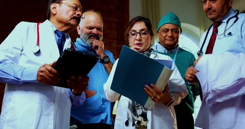 Group of indian doctors and surgeons discussing case in hispital while standing Stock Footage 342806929