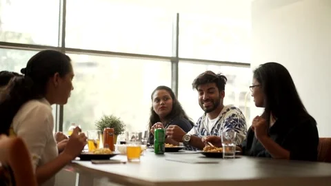 Group of Indian friends having a meal together and talking Stock Footage 229781553