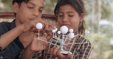 Group of Indian kids learning from practical experiments from teacher mentor Stock Footage 125855717