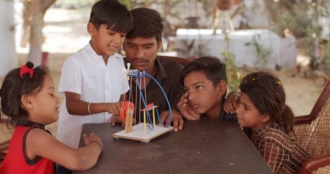 Group of Indian kids learning from practical experiments from teacher mentor Stock Footage 125855995