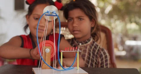 Group of Indian kids learning from practical experiments from teacher mentor Stock Footage 125856516