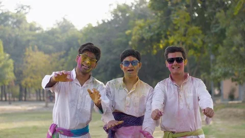 Group of Indian people in white Kurta Pajama wishing Happy Holi festive scene