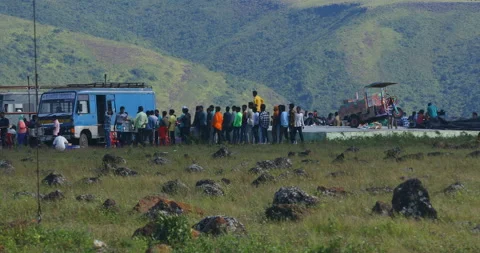 A group of Indian poor workers stand patiently in a long queue Stockbeeldmateriaal 326754054
