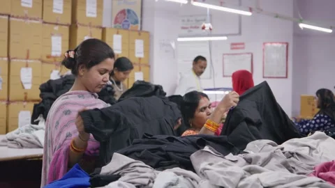 Group of Indian women workers checking dresses in a textile workshop Stock Footage 243641803