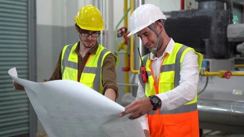 Group of Industry Engineer discussion with Blueprints checking information an Video stock 154283475